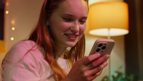 woman smiling and looking at her phone