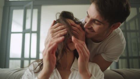 Young-man-giving-massage-to-woman-while-working-at-home