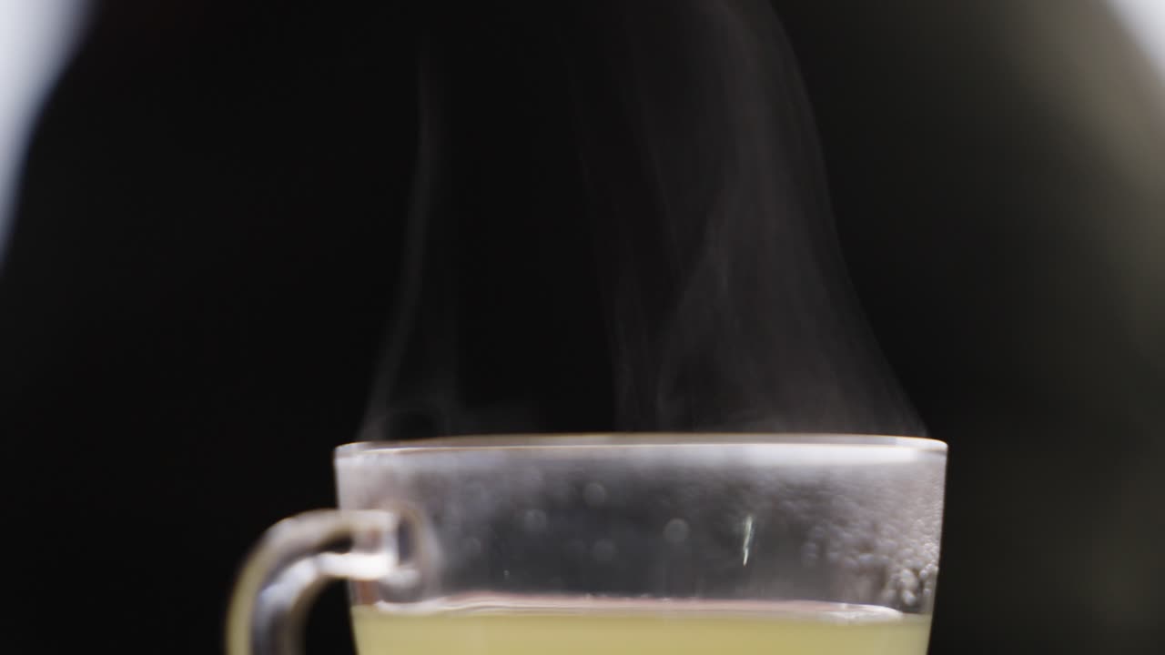 hot lemon tea in a glass and steam rising from it
