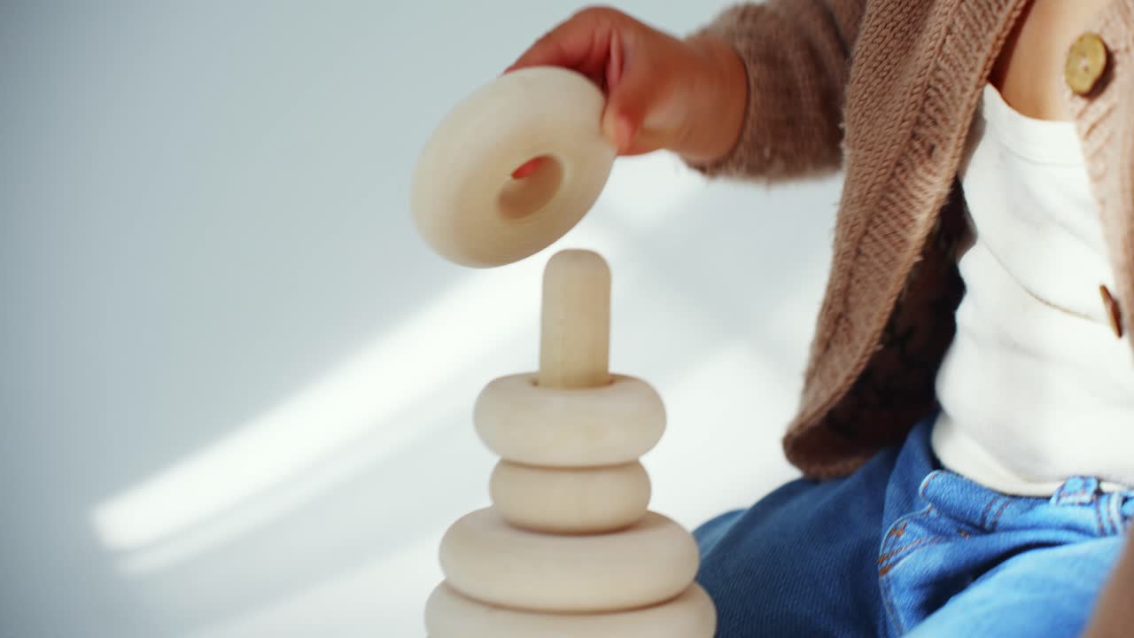 Close-up of Baby's Hands Playing with Wooden Stacking Toy
