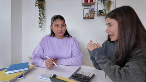 two students studying at a table