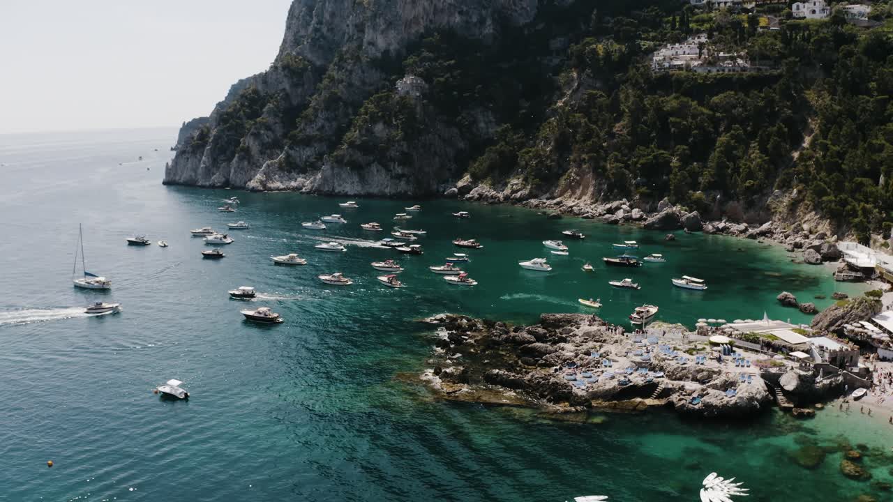 Aerial view of Italy's unique coastline filled with boats and tourist resorts