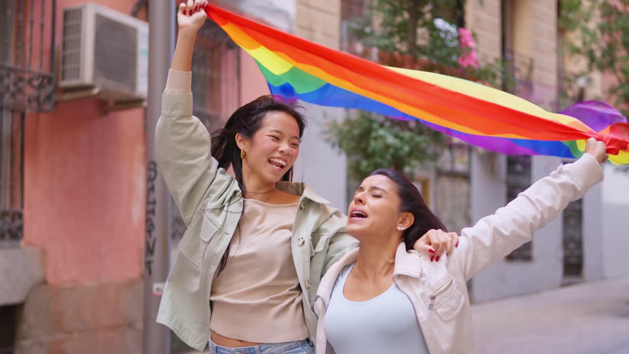 Joyful Diverse Women Running with LGBTQ+ Pride Flag
