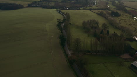 aerial drone tilting up to reveal the country road amongst a vast landscape
