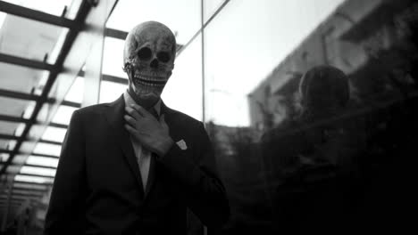man in a skull mask business suit