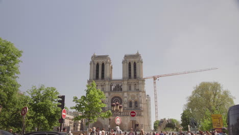 traffic at notre dame cathedral in paris france on a sunny day in april. 4k