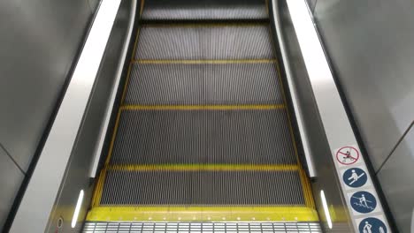 Escalator moving, going upward, at base floor, 4K