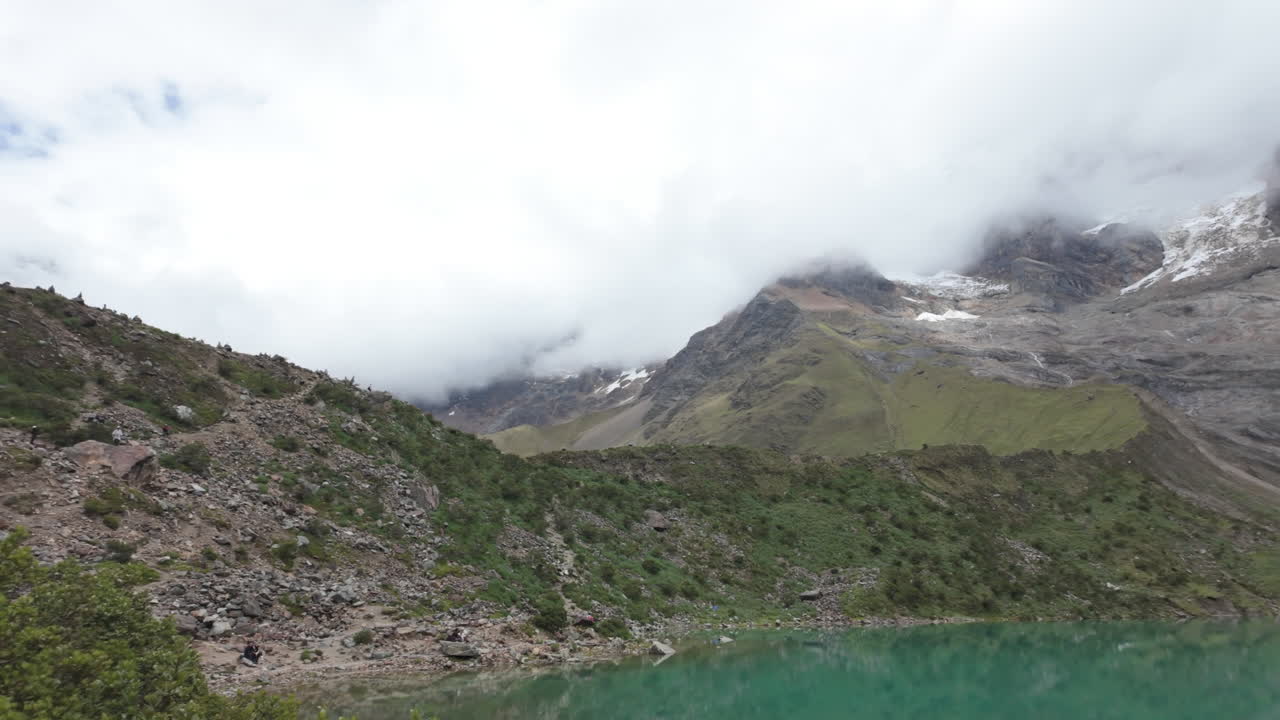 Turquoise Humantay Lake with snow-capped Humantay and Salkantay peaks in slow motion