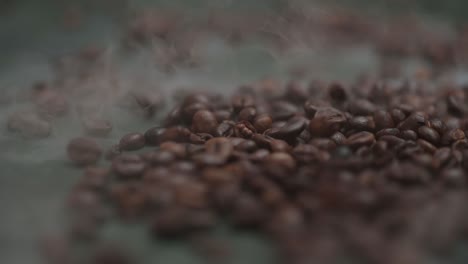 coffee beans falling, spilling onto the table in smoke, fog