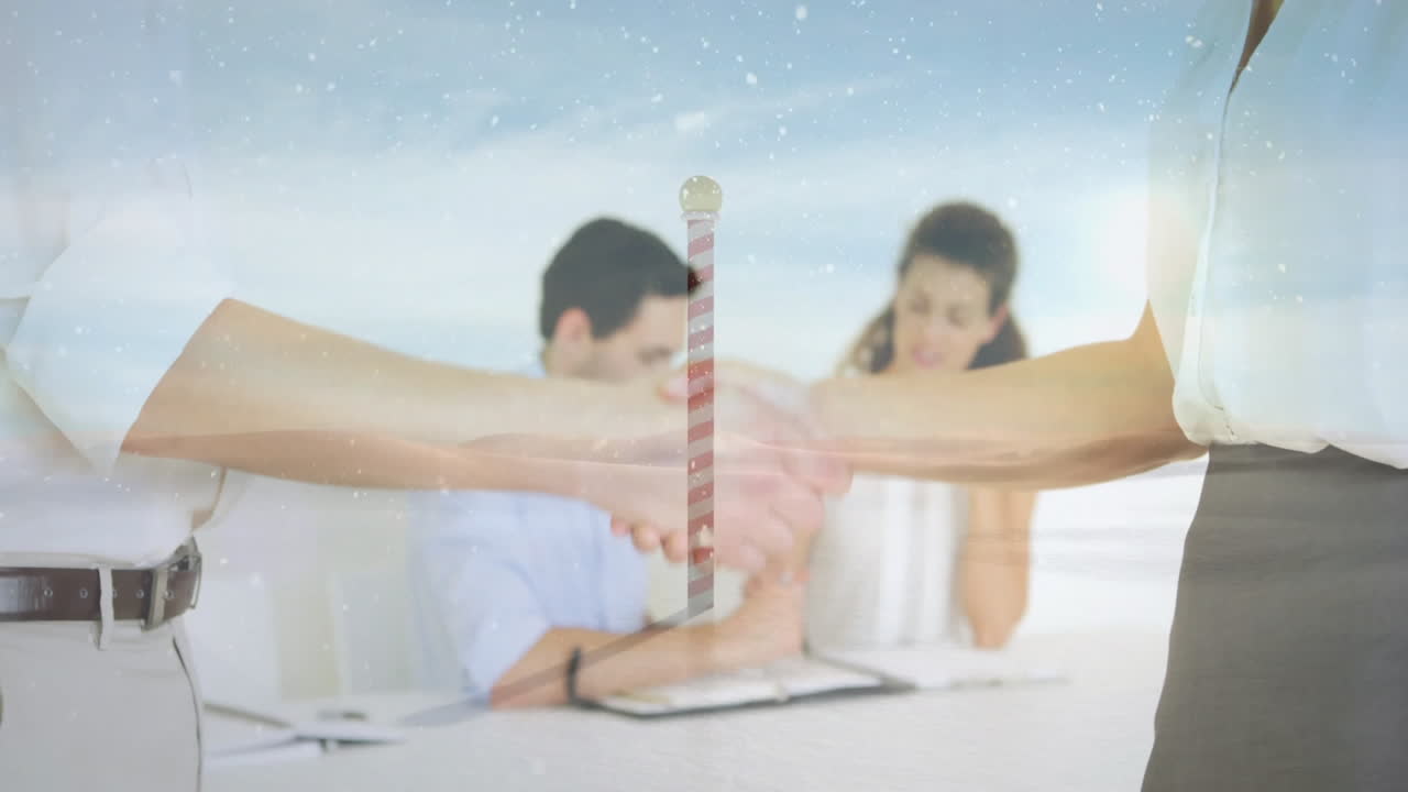 Handshake over business meeting with snowy landscape and barber pole animation