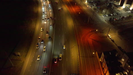 Aerial-view-of-Tilting-Shot-of-Cars-Driving-Down-the-Highway-at-Night-in-Denver,-Colorado