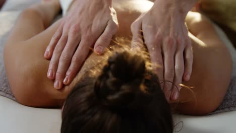 male physiotherapist giving back massage to female patient