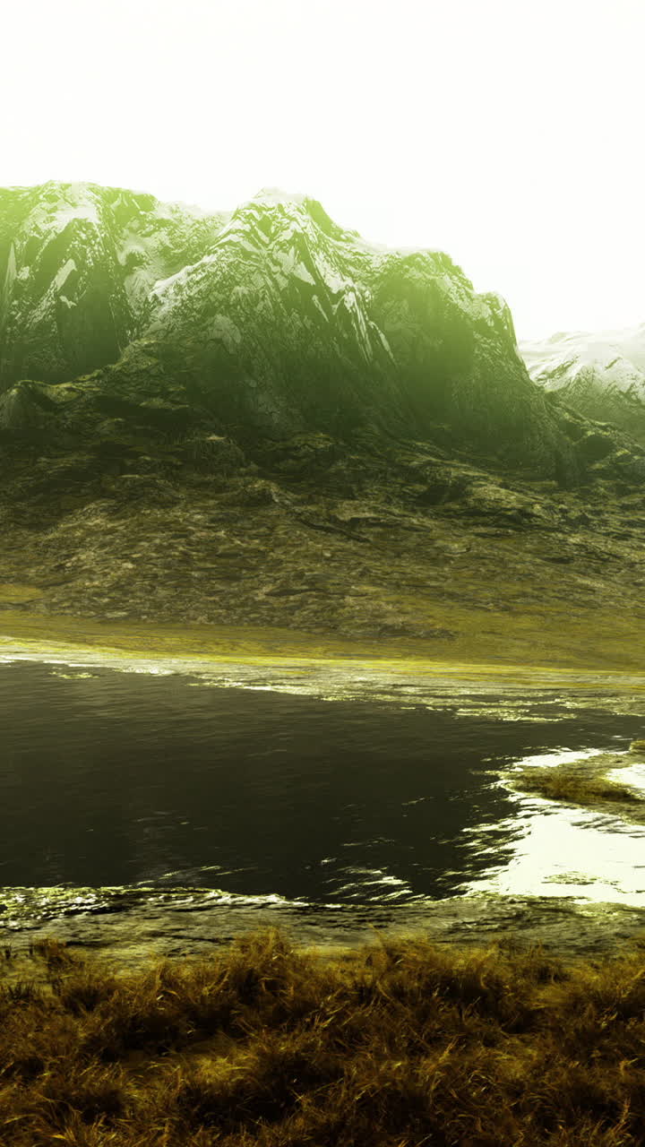 Mountain landscape with a serene lake reflecting sunlight in the afternoon