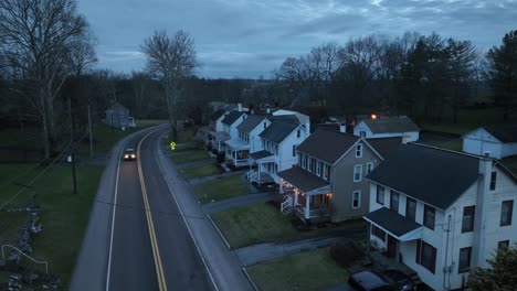 white car on main street in noble american neighborhood