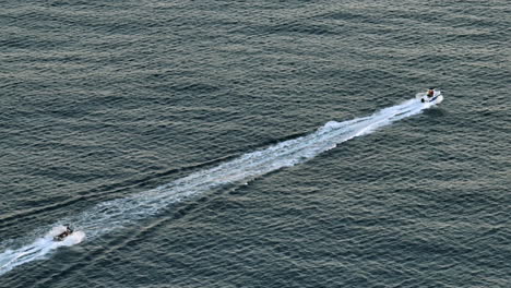 drone footage showing a boat speeding across the open ocean in australia