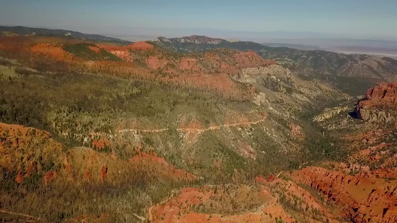 Aerial View of sandstone canyon and high mountain forest in wildfire burn area, smoke and haze