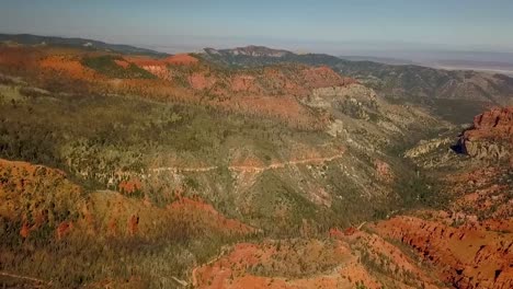 aerial view of sandstone canyon and high mountain forest in wildfire burn area, smoke and haze