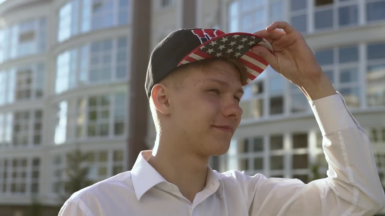 Young Man Wearing Baseball Cap with American Flag