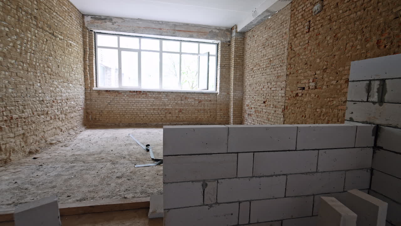 White brick wall added in the room with orange brick room. Large window is in the front wall at backdrop.