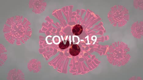 Animation-of-floating-macro-Covid-19-cells-and-text-Covid-19-over-falling-pills