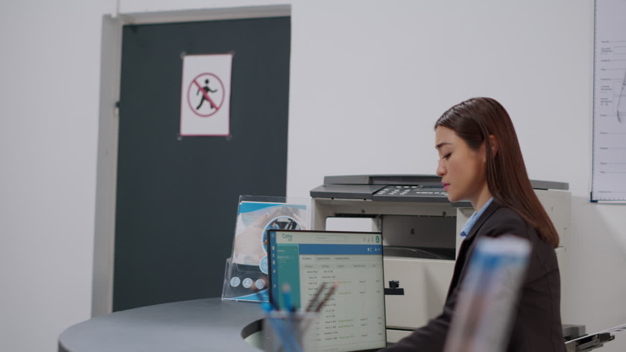 Receptionist assisting patient with neck brace at reception desk
