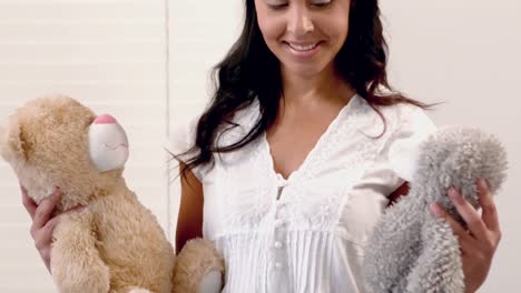 madre sonriente sosteniendo un oso de peluche
