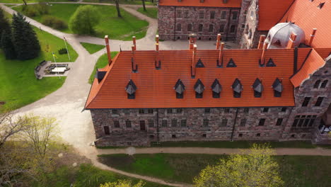 aerial view of cesvaine castle with red roofs and stone walls