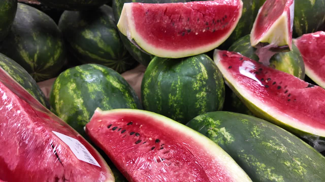 Fresh Watermelons, Whole and Sliced, on Display