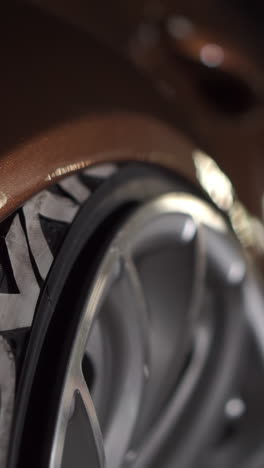 close-up of a car's wheel and tire with custom modifications.