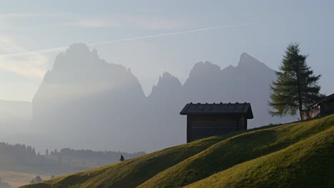 sunrise in the alps: secluded cabin and majestic mountains