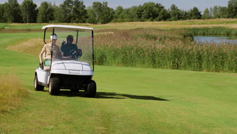 caucasian woman and african american man on the golf course.