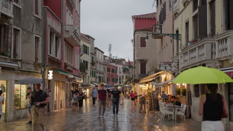 people walking down a street in venice, italy