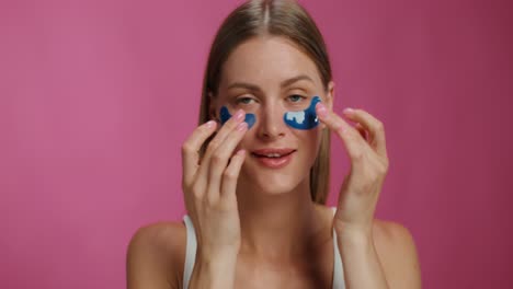 woman applying eye patches