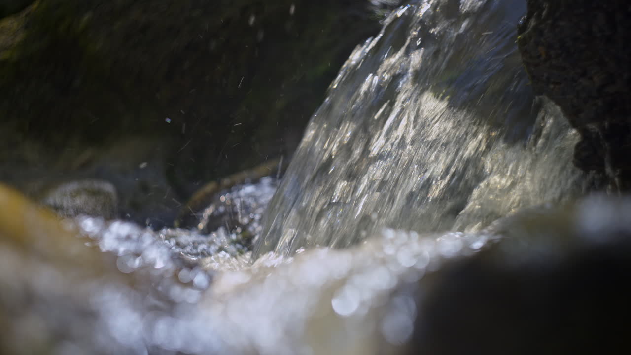 Close-up of a Small Waterfall Flowing over Rocks