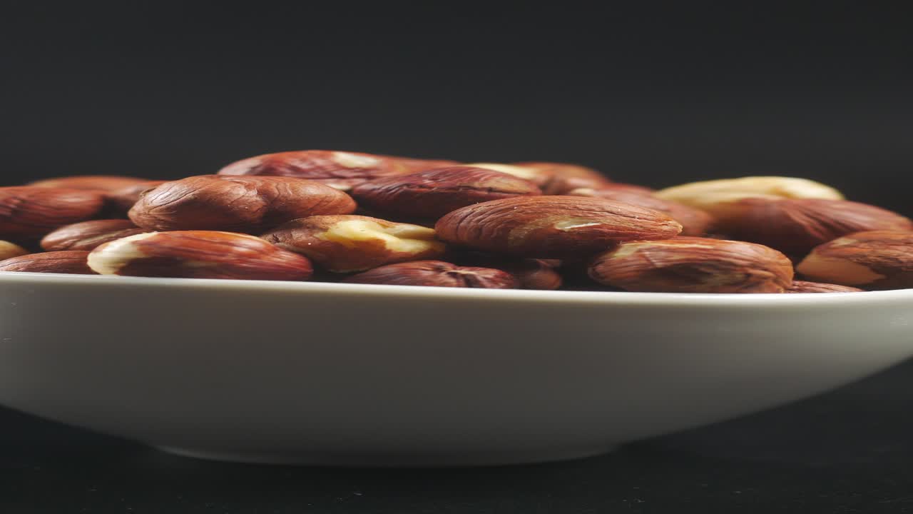 Close-up of hazelnuts in a white bowl