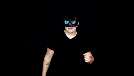 young man with vr goggles waving to camera and starts running