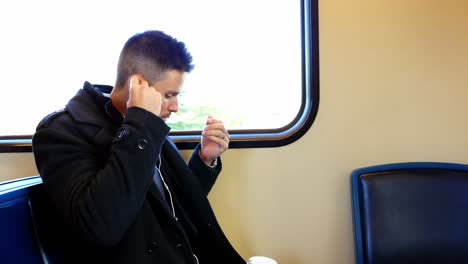 businessman listening to music while travelling