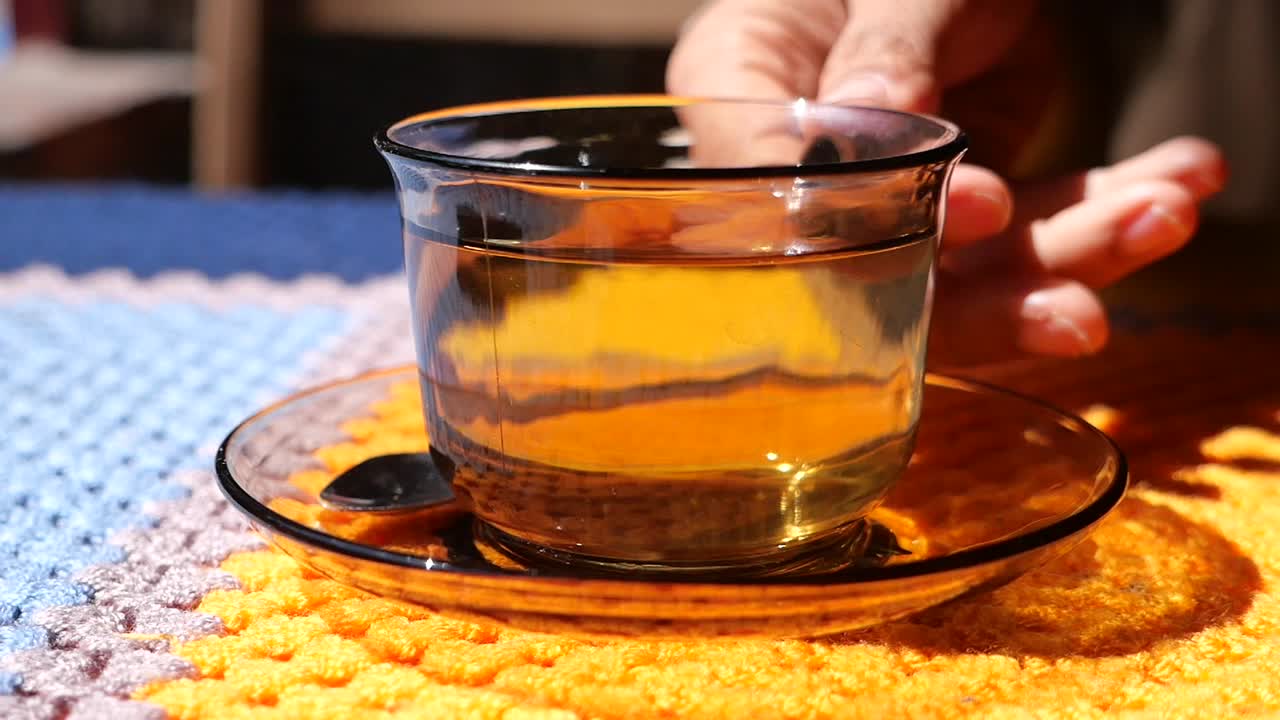 A glass of tea on a knitted tablecloth