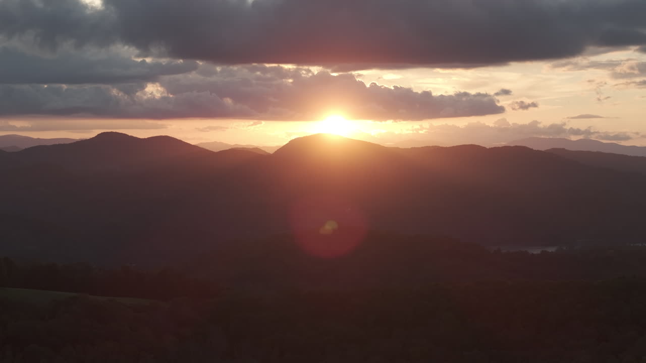 Breathtaking drone view of the Blue Ridge Parkway surrounded by brilliant fall foliage at sunset