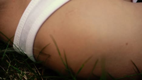 girl's feet walking through grass in slow motion