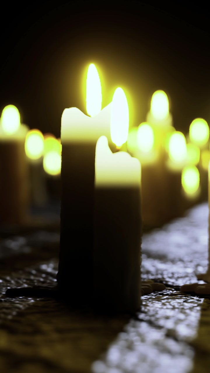 Candele che bruciano dolcemente su una superficie scura durante un raduno serale