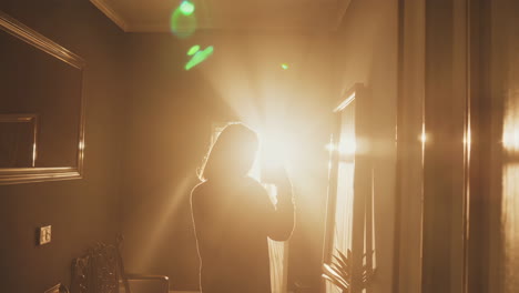 silhouette of a person in a bright room