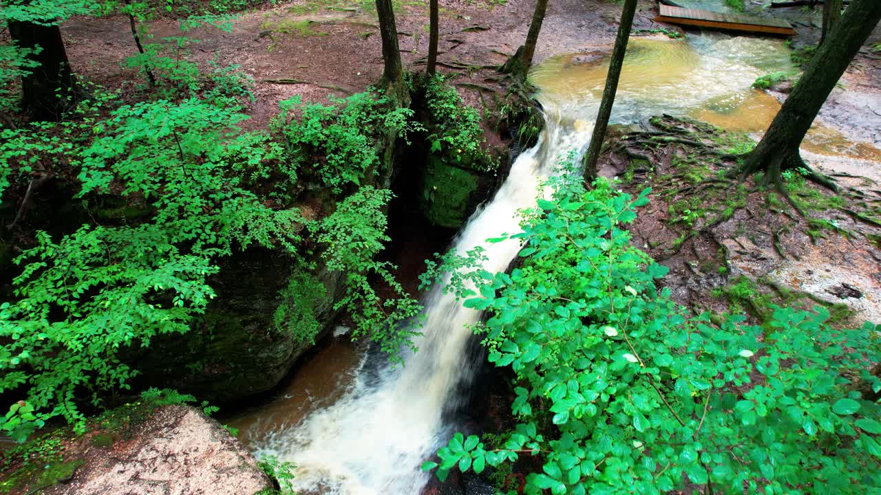 una foto de un dron de una cascada cae en un día soleado en el parque estatal nelson-kennedy ledges en el noreste de ohio