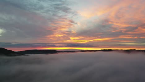 sunrise/sunset over misty mountains