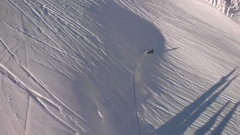 fotografía aérea de una moto de nieve en las colinas nevadas del parque nacional de revelstoke, canadá