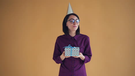 woman with gift and party hat