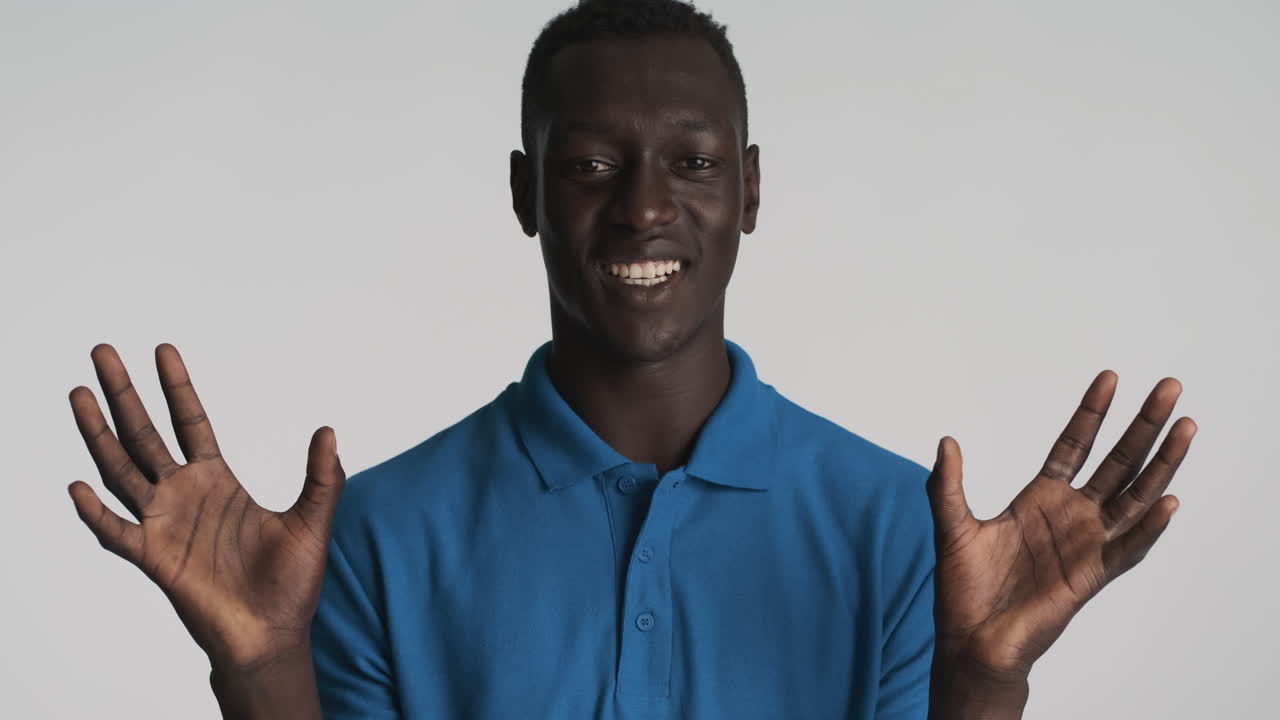 Funny African american man on grey background.