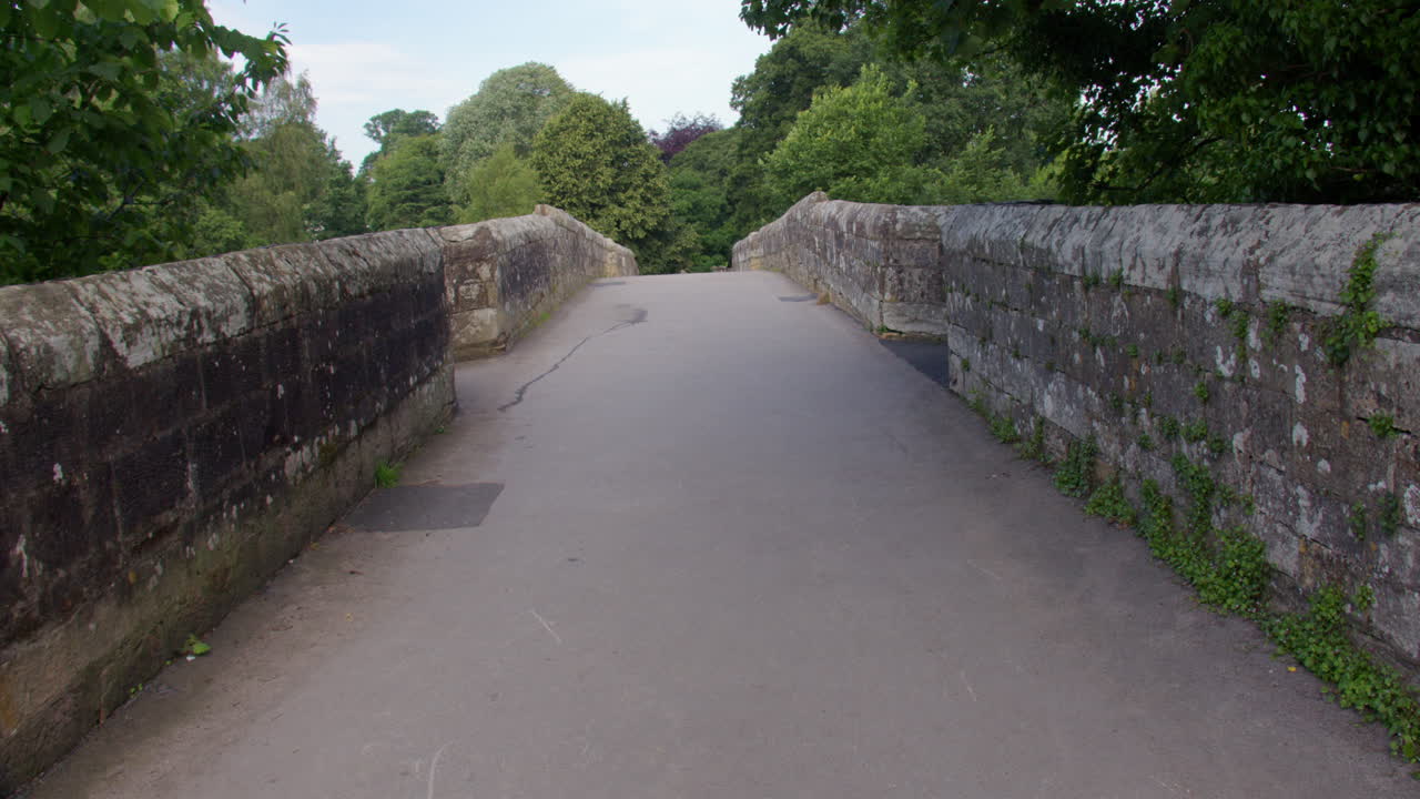 Wide panning shot looking on to devils bridge at Kirkby Lonsdale, North Yorkshire