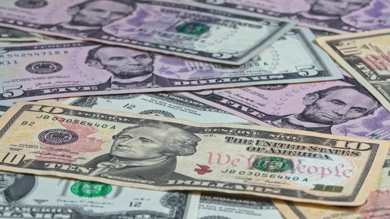 Various banknotes spread on a flat surface showing United States currency