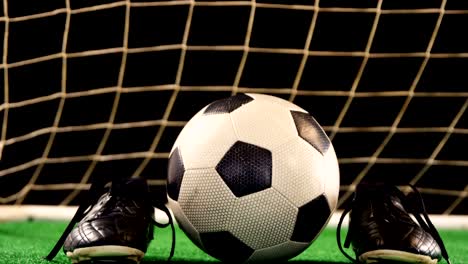 close-up of football and cleats on artificial grass 4k